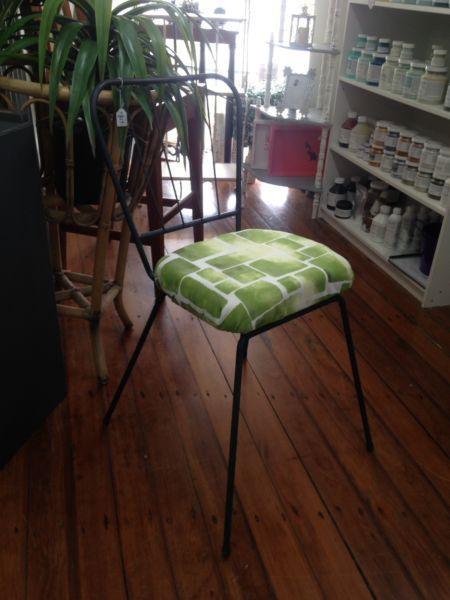 Metal chair with padded green seat