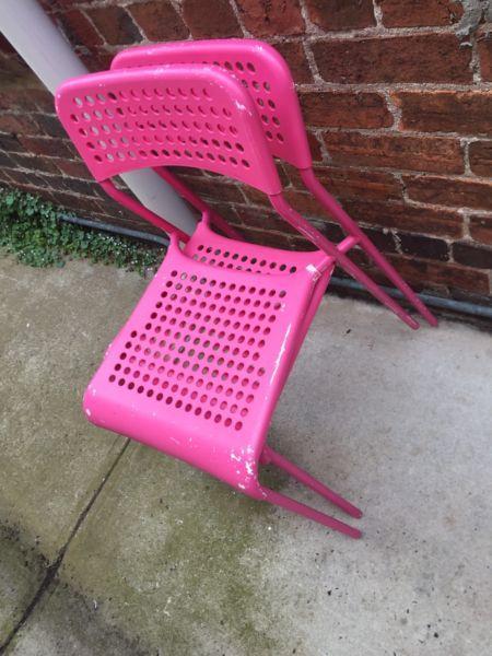 Two Pink Metal Chairs