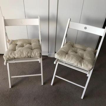 2 white IKEA folding chairs with cushions brand new