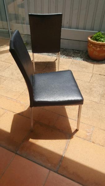 Black vinyl dining chairs. Brushed chrome legs