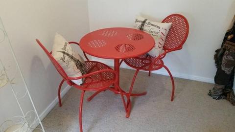 red metal table and chairs