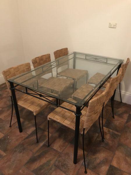 Wrought iron glass table top dining suite with cane/wicker chairs