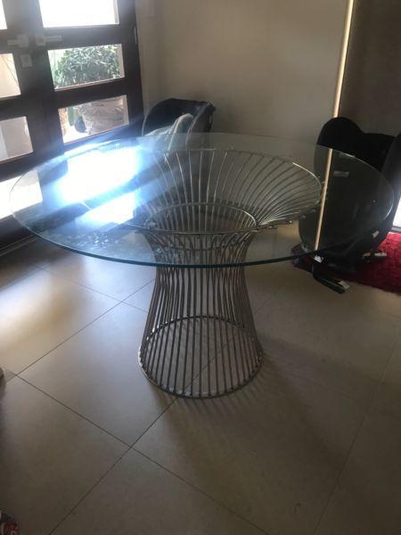 Glass dining table with steel base