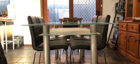 Glass dining table and 6 black chairs