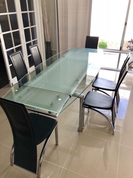Glass dining table 6 black leather look chairs