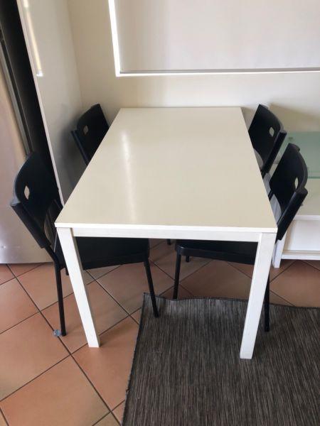 White Table with 4 black chairs