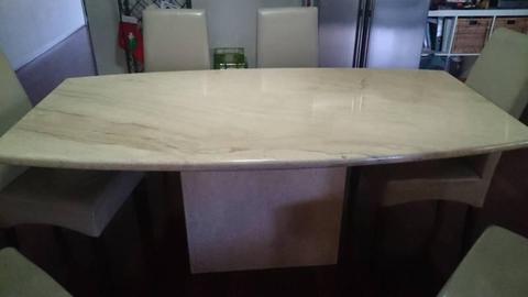 Travertine dining table with leather chairs