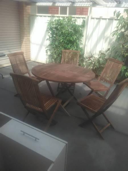 Around table 5 chairs pure teak looking for $200 has been sanded