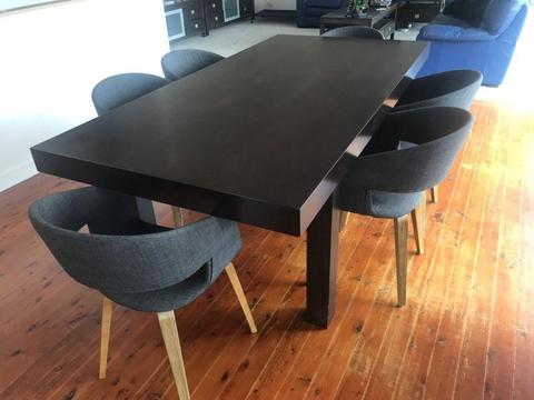 Solid dark brown dining table in good condition