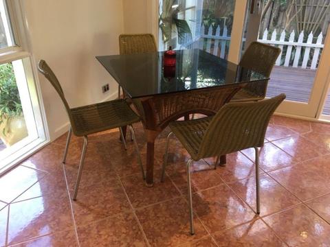 Cane dining table with glass top & 4 chairs