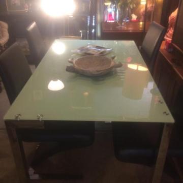 glass top table with chrome legs and 4 leather and chrome chairs