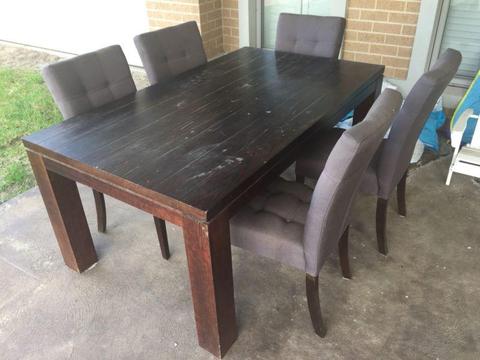 Solid timber dining table and entertainment unit together