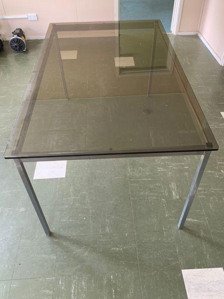 Tinted glass dining table on metal frame