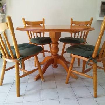 Round Pine table and four matching chairs