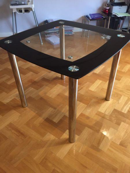 Black glass dining table with chairs