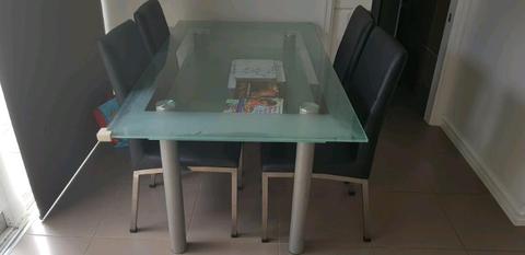 6 seater 2-tier glass table plus 6 black chairs