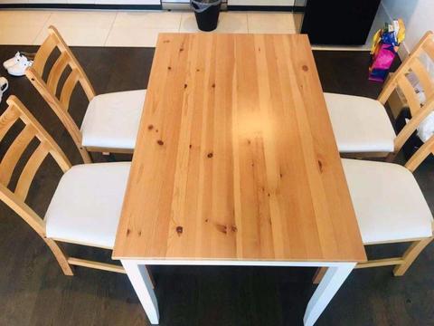 Ikea tables and four matching chairs are on sale at a low price