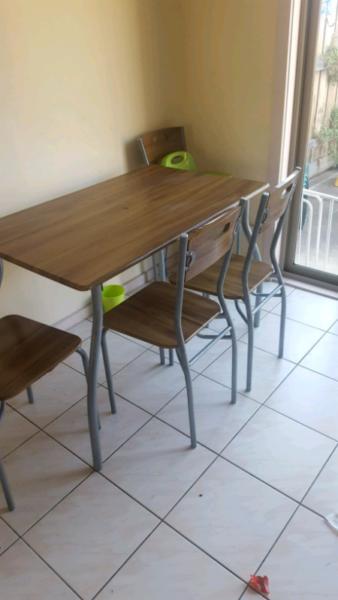 Small dinning table with 4 chairs..Fair condition