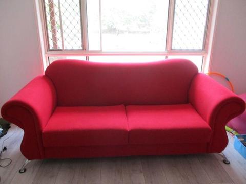 Red Two Seater Lounge with 2 matching Armchairs. Good Condition
