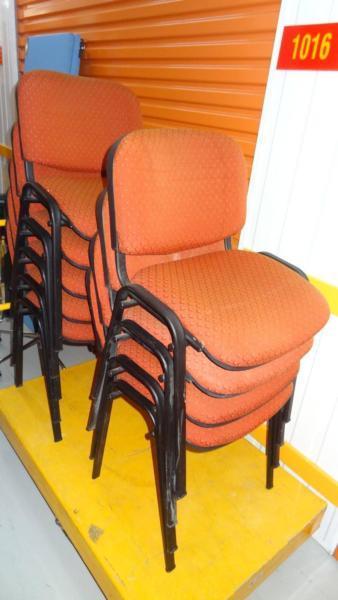 9 orange fabric upholstery stacking chairs with metal frames