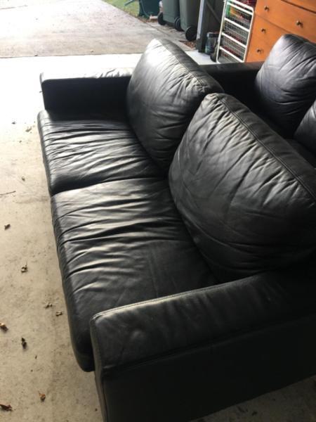 2 black leather lounges 1 x 2 seater and 1 3 seater