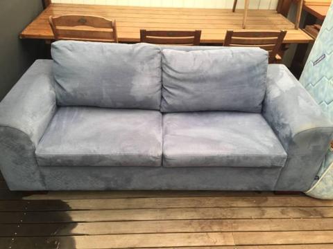 Blue fabric two seater pull out bed couch
