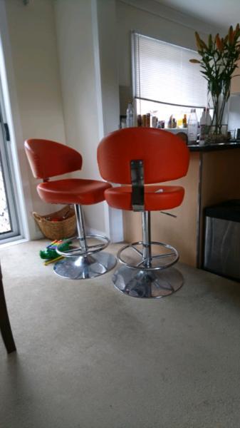 Two Orange Bar Stools