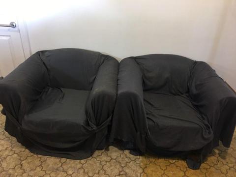 Two blue single seater couches with covers