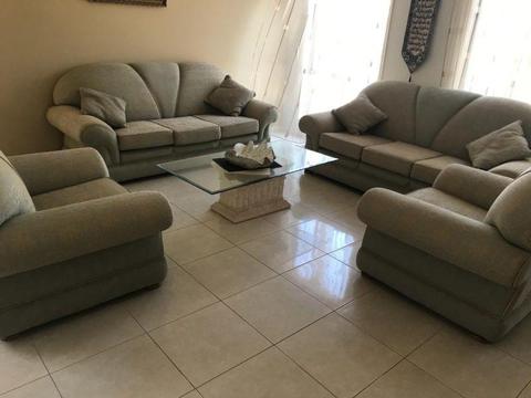Couches, dining table and stand with glass shelves for sale