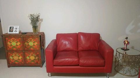 Two red leather couches