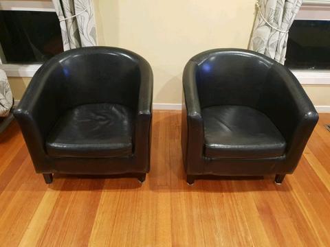 Two Faux leather single sofas black