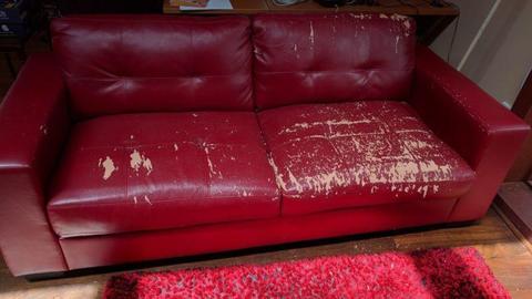 Red three seater leather couch