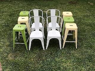 Rustic white chairs and green and yellow stools