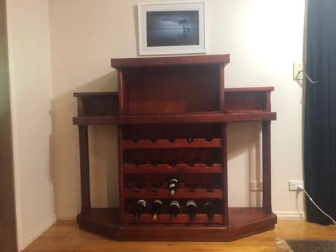 Solid red stained wood wine rack