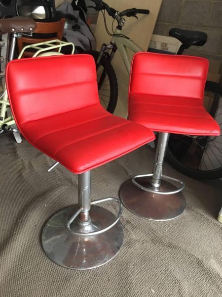 Two red bar stools