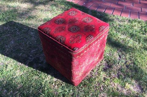 Chic cubic ottoman upholstered with genuine red woolen Afghani rug