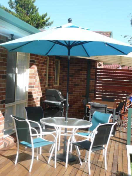Small outdoor glass table and 4 chairs plus umbrella and stand