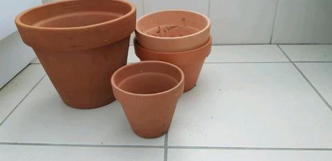 Set of four terracotta garden pots