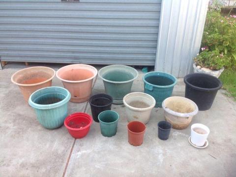 A dozen plant pots mostly large