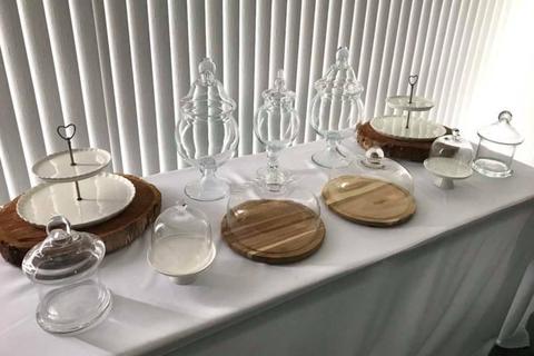 Assorted apothecary jars and stands for dessert table