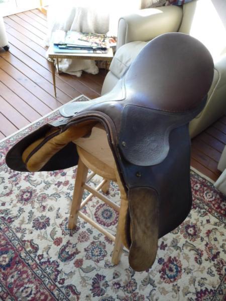 horse saddle ; vintage style aged leather on timber stand