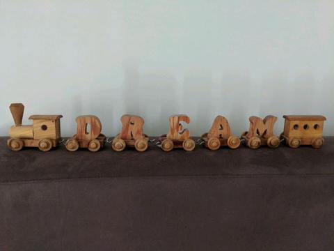 Wooden train spelling out DREAM