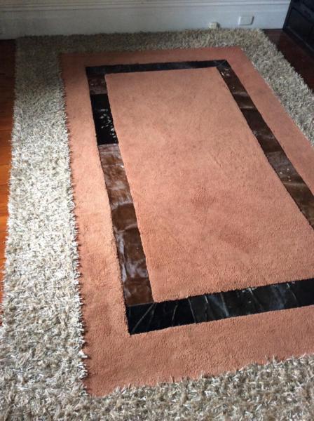 BOLD MODERN RUG with cowhide feature and ruffle border