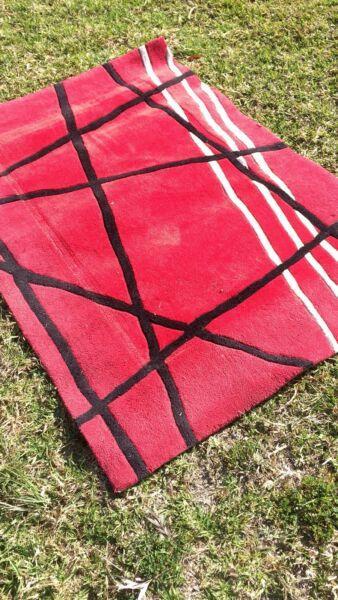 A beautiful red black and white rug