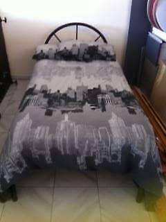 1 Double Bed White Doona & 2 white Pillows with a CityScape Patte
