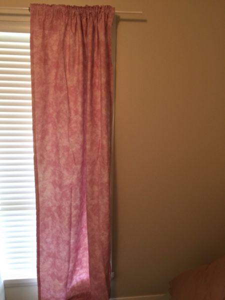 1 pair of light pink rubber backed curtains