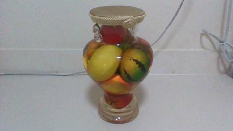 Large glass jar with brightly coloured exotic fruits