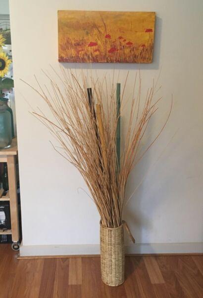 Rattan basket with real dried plants and 3 colorful bamboo sticks