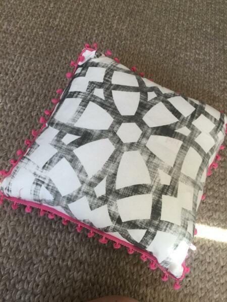 Stylish Patterned Cushion with Pom Poms