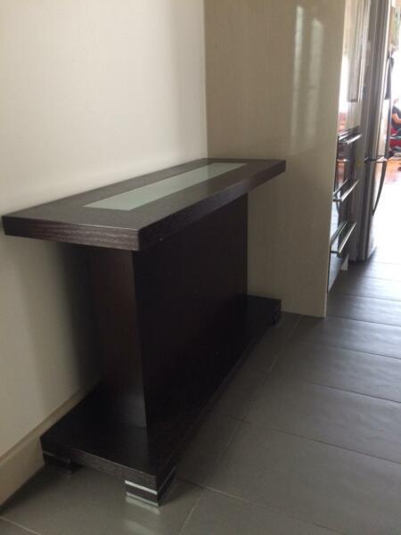 all black timber console with central glass feature plate